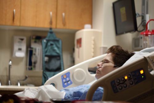 A patient reclined in a hospital bed. Patients can benefit from a variety of healthcare technology.