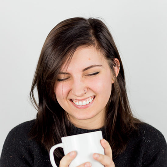 Woman holding coffee cup smiling
