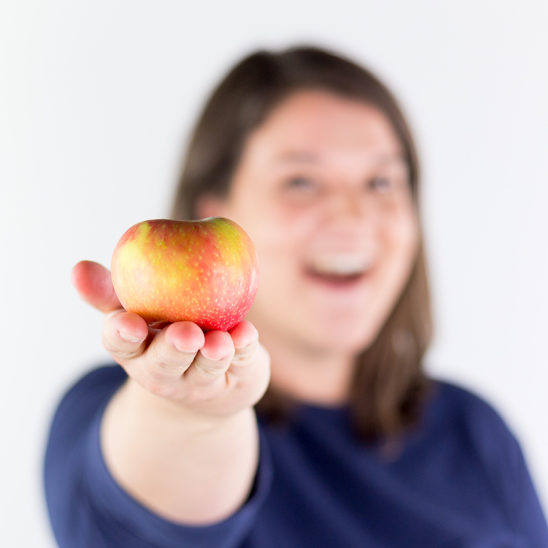 Rose smiling and holding an apple