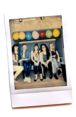 Me and four other Fuzzy Mathers smiling while sitting side-by-side on a couch underneath multi-colored balloons.