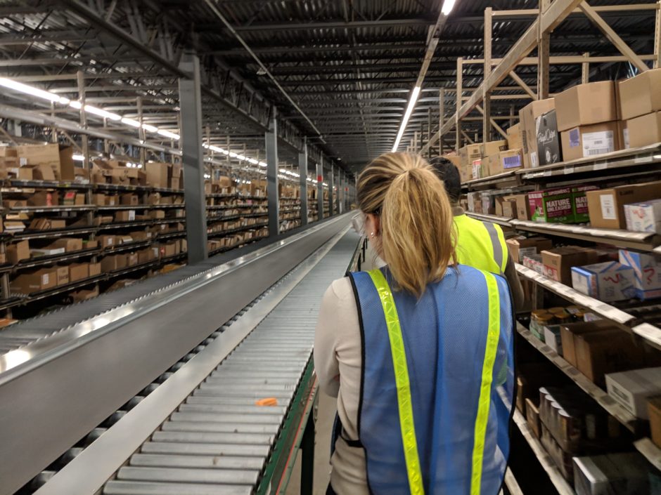 Fuzzy Math researcher conducting in-context research in a warehouse. Initial research is an important step in developing a clear digital transformation strategy.