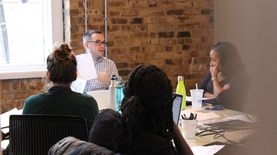 A group of three UX designers conducting a user interview. This is a typical day in the life of a ux designer.