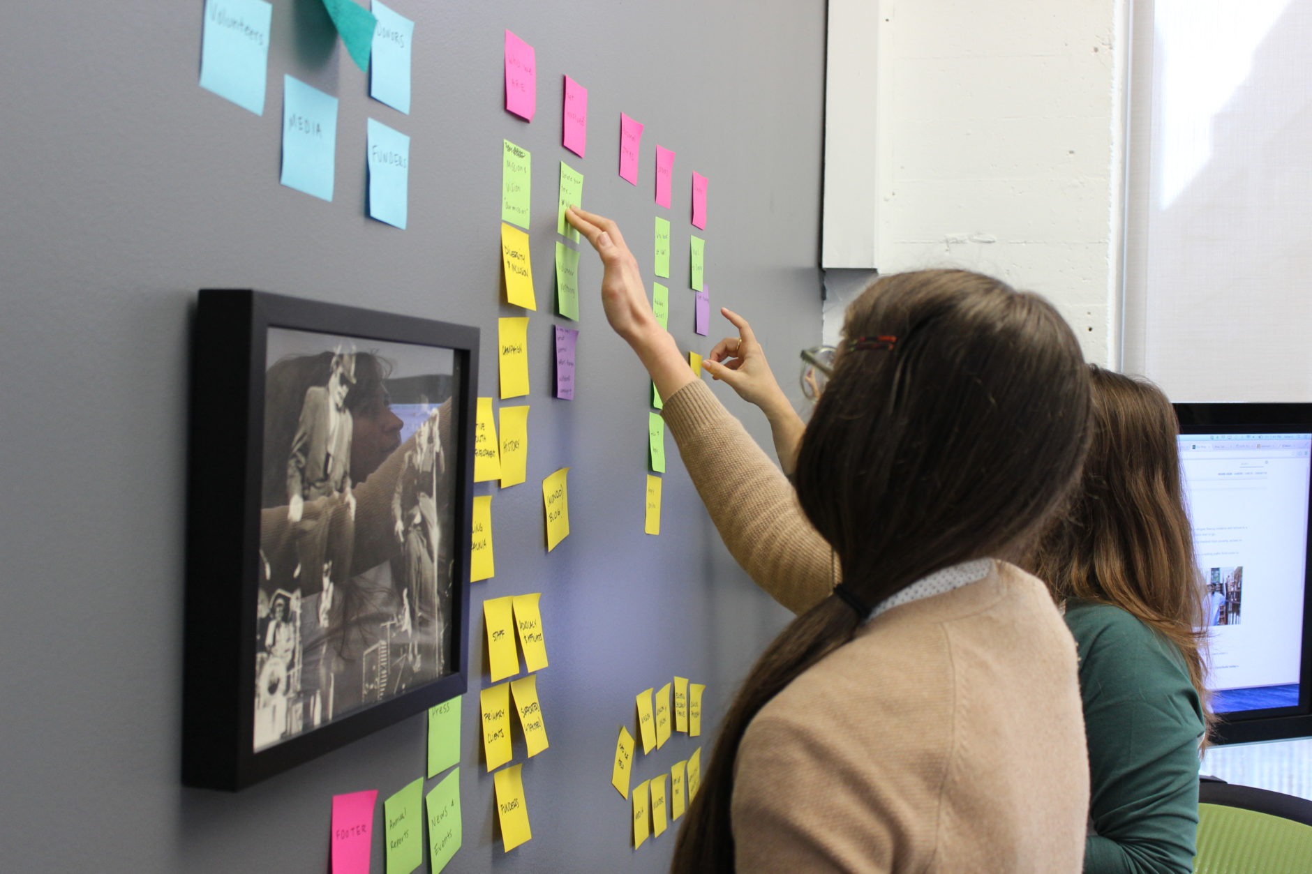 How to create an awesome product strategy - teammates working with sticky notes