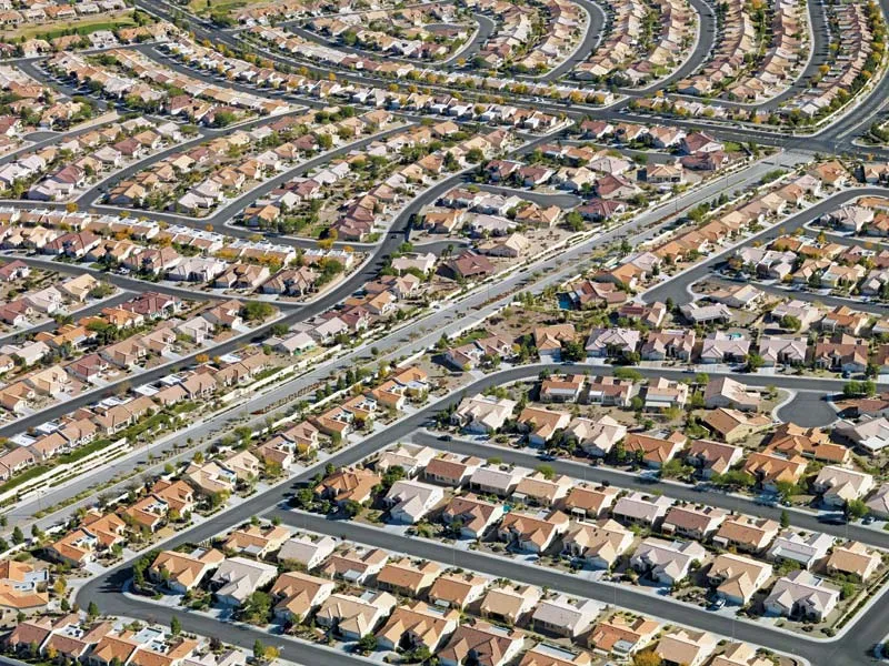 An image of unending rows upon cul-de-sacs of low density homes